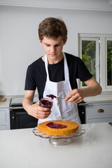 A Teenage Boy Cooking In A Kitchen