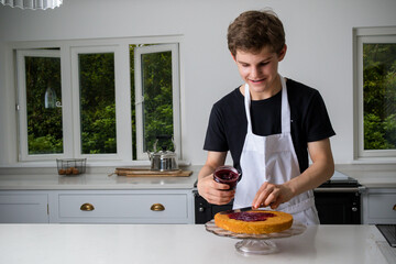 A Teenage Boy Cooking In A Kitchen