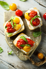 Tomato crostini with cream cheese and fresh basil	