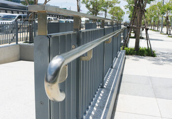 Stainless steel railing installed on metal fence in the park.