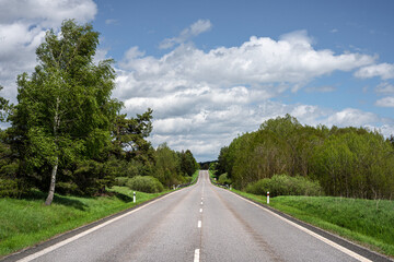Fototapeta na wymiar The asphalt road across a beautiful landscape.