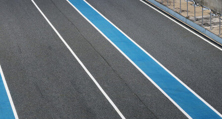 Asphalt racing track with marking line top view background.