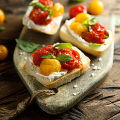 Tomato crostini with cream cheese and fresh basil	