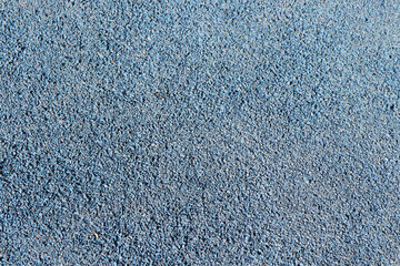 Blue running track synthetic rubber surface pattern texture background.	