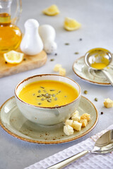 Tasty and healthy dietary food. Pumpkin soup cream on a gray background