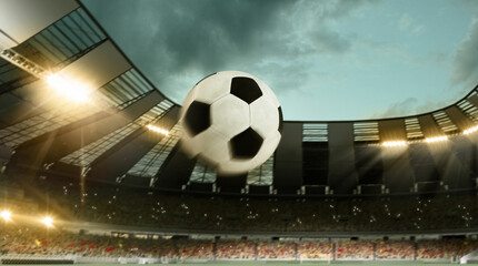 Flight of soccer football ball through crowded stadium with spotlights in evening time. Concept of...