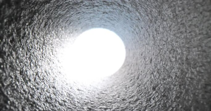 Bright white light at end of tunnel pipe