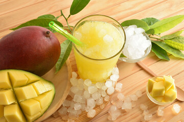 Detail of glass with mango juice with ice on table