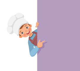 cute little boy in chef hat and apron peeking from board pointing finger to empty banner for copy space