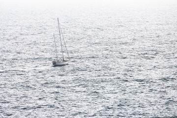 Lonely sailing boat on the azure sea of Liguria, Italy