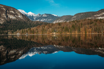 Autumn landscape by the lake Bohinj in Julian Alps. Fascinating reflectins in the lake on a cloudy...
