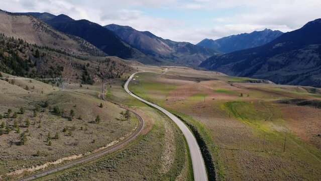 Drone flying over highway as RV drives away