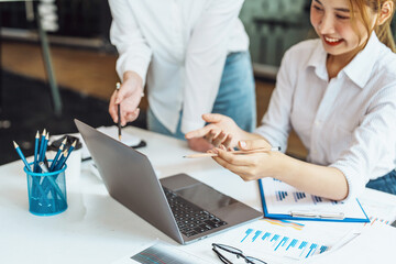Negotiation, Analysis, Discussion, Asian woman economist and marketer using computer laptop to plan...