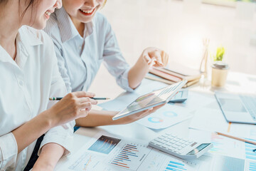 Negotiation, Analysis, Discussion, Portrait of an Asian women economist and marketer using tablet...