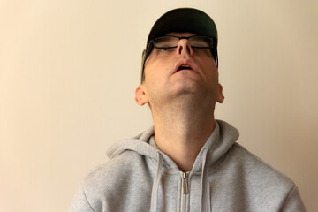 The man with glasses is looking up