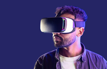 Young man using virtual reality headset, VR, future gadgets, technology, virtual event, education, learning, video game concept, Portrait of modern guy using vr glasses over black background