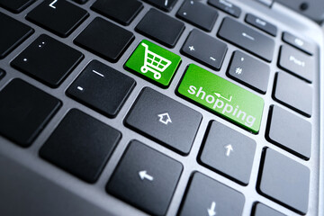 close-up part of a laptop, black keyboard of a laptop computer, green buttons with the word download, concept of installing and using buyer's personal account, online shopping, global business