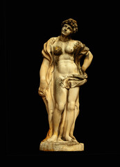 Antique Olympic goddess of love and beauty Aphrodite (Venus) Fragment of ancient statue isolated on black background.