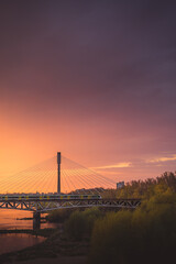 Obraz premium train on bridge with sunset in background