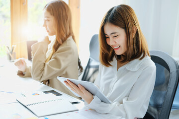 Negotiation, Analysis, Discussion, Portrait of an Asian women economist and marketer using tablet...