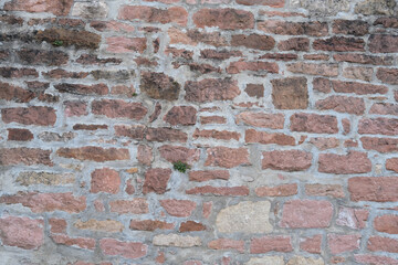 Obraz premium texture of an old light brick stone wall, background, rough sandy texture of an old medieval stone wall, abstract patterns. Background for design, copy space