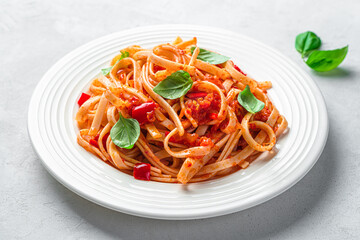 Italian linguini pasta with tomato sauce and fresh basil close-up. Italian food. Side view.