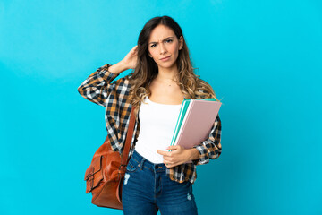 Young student woman isolated on blue background having doubts