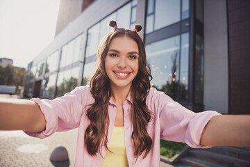 Self-portrait of attractive cheerful wavy-haired girl traveling spending time having fun on fresh air outdoors