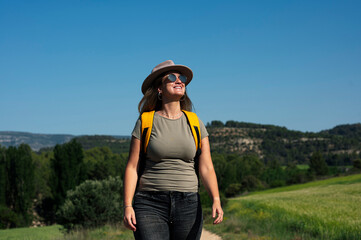 Woman with hat on a happy day in nature.