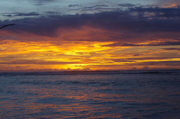 Naklejka na ściany i meble Sunset over the Indonesian coastline