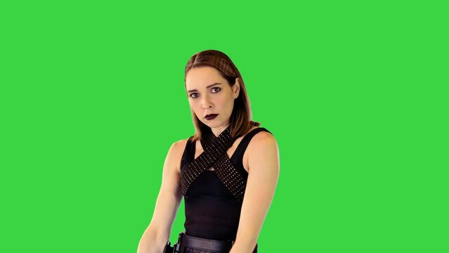 Shooter-character girl gets a gun out of holster and takes an aim on a Green Screen, Chroma Key.
