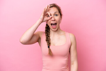 Young caucasian woman isolated on pink background showing ok sign with fingers