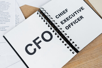 top view of notebook with cfo and chief executive officer lettering.