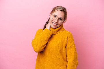 Fototapeta premium Young caucasian woman isolated on pink background laughing