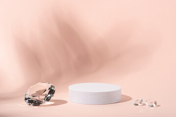 White podium with diamonds on a pink background for product presentation. Minimal concept and hard sunlight.