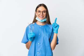 Lithuanian woman dentist holding tools over isolated background pointing up a great idea - obrazy, fototapety, plakaty