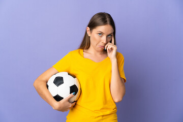 Young Lithuanian football player woman isolated on purple background thinking an idea