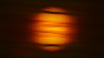 Dark orange color of sun behind the window