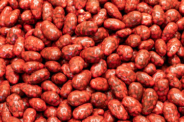 Dragee with raspberry filling. Pistachio dragee. Sweet snack. close up