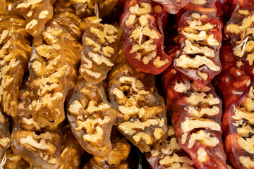 Walnut sausage with pomegranate walnuts and yellow grapes. Sweet snack. Close-up. local name cevizli sucuk