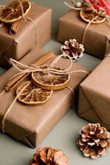 Eco-friendly wrapped gift against green background. Zero waste concept.Natural decoration.Vertical shot