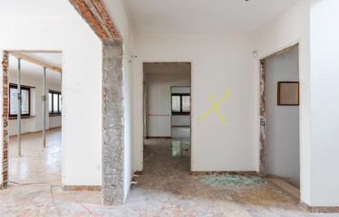 Large room with props fixed to the ceiling of an old villa undergoing demolition and renovation
