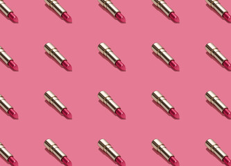 Creative seamless pattern of vivid pink golden lipsticks on bright pink background. Trendy and fashion makeup concept. Romantic concept.