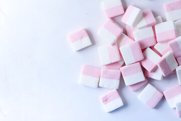 Fototapeta na wymiar marshmallow candy on white background top view 