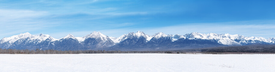 Winter landscape panorama with Sayan Mountains in Siberia on sunny winter day. Natural background.