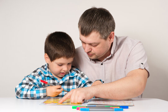 Father and son go through labyrinths, perform tasks for logic and the development of thinking in preparation for school.