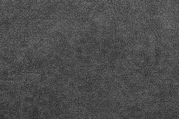 Black fabric soft texture of a terry towel close-up.