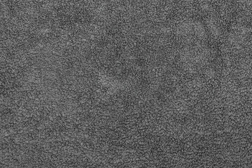 Black fabric soft texture of a terry towel close-up.