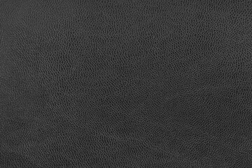 Black leather background texture for designers.black skin. black background texture with pattern. Textured surface of dark skin product