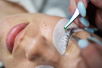 eyelash extension close-up. female eyelashes, under them there are patches with the size of the...